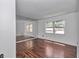 Spacious bedroom with hardwood floors, a mirrored wall, and bright natural light at 2837 Ne 3Rd St # 103, Ocala, FL 34470