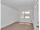 Cozy bedroom featuring neutral carpet, a large window, and closet for storage at 2837 Ne 3Rd St # 103, Ocala, FL 34470