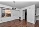Sunlit dining area with new hardwood floors, neutral walls and vintage chandelier at 2837 Ne 3Rd St # 103, Ocala, FL 34470