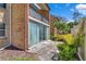 Exterior view of condo featuring sliding glass doors and a private balcony nestled among lush landscaping at 2837 Ne 3Rd St # 103, Ocala, FL 34470