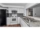 Well-lit kitchen with granite countertops, modern appliances, and a convenient passthrough at 2837 Ne 3Rd St # 103, Ocala, FL 34470