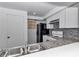 Updated kitchen featuring modern appliances and granite counters overlooking stainless steel sink at 2837 Ne 3Rd St # 103, Ocala, FL 34470