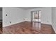 Sunlit living area featuring hardwood floors, neutral walls and sliding door to outdoor living at 2837 Ne 3Rd St # 103, Ocala, FL 34470