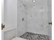 Updated shower with marble-style tile and mosaic floor adds a touch of elegance to this bathroom at 2837 Ne 3Rd St # 103, Ocala, FL 34470