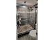 Sleek bathroom featuring glass shower, dark grey tile, and modern fixtures at 2843 Ne 3Rd St # 109, Ocala, FL 34470