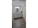 Bright bathroom with a double sink vanity, granite countertops, white cabinets, and wood-look floors at 2843 Ne 3Rd St # 109, Ocala, FL 34470