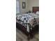 Bedroom featuring wood-look floors and a full-sized bed with a blue and white patchwork quilt at 2843 Ne 3Rd St # 109, Ocala, FL 34470