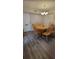 Dining room with wood floors features a round table and contemporary chandelier at 2843 Ne 3Rd St # 109, Ocala, FL 34470