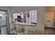 Breakfast bar with granite counters overlooks kitchen with stainless steel appliances at 2843 Ne 3Rd St # 109, Ocala, FL 34470