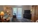 Living room features sliding glass doors to balcony, and a comfortable sofa at 2843 Ne 3Rd St # 109, Ocala, FL 34470