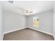This is a bedroom with wood-look flooring, ceiling fan, a window for natural light at 4073 Se 136Th Pl, Summerfield, FL 34491