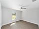 Bright bedroom features wood-look flooring, ceiling fan, and a window offering lots of natural light at 4073 Se 136Th Pl, Summerfield, FL 34491