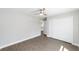 This bedroom is spacious and has wood-look flooring, closet, and ceiling fan at 4073 Se 136Th Pl, Summerfield, FL 34491