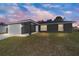 Charming single-story home with an attached two-car garage and a well-manicured lawn at 4073 Se 136Th Pl, Summerfield, FL 34491
