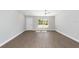 Bright living room featuring wood-look floors and neutral paint at 4073 Se 136Th Pl, Summerfield, FL 34491