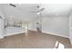A view of the home's open concept living space featuring wood-look floors and stainless steel appliances at 4073 Se 136Th Pl, Summerfield, FL 34491