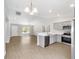 Open-concept living space includes a modern kitchen featuring stainless steel appliances and a breakfast bar at 4073 Se 136Th Pl, Summerfield, FL 34491