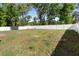 View of the spacious backyard featuring a white fence and a storage shed at 4243 Se 131St Ln, Belleview, FL 34420