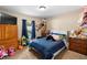 Cozy bedroom featuring carpet floors, a window view, and plenty of room for toys at 4243 Se 131St Ln, Belleview, FL 34420