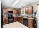 Well-lit kitchen featuring granite counters, stainless steel appliances, and warm wood cabinetry at 4243 Se 131St Ln, Belleview, FL 34420