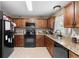 Well-lit kitchen featuring granite counters, stainless steel appliances, and warm wood cabinetry at 4243 Se 131St Ln, Belleview, FL 34420