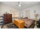 Comfortable bedroom featuring dresser, nightstands, and a ceiling fan at 4410 Ne 13Th St, Ocala, FL 34470