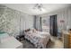 Cozy bedroom featuring unique textured walls, a comfortable bed, and a window for natural light at 4410 Ne 13Th St, Ocala, FL 34470