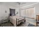 Simple bedroom with natural light, ceiling fan, and hard wood floors at 4410 Ne 13Th St, Ocala, FL 34470