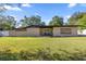 Inviting single-story home featuring a well-maintained lawn and covered entryway with decorative concrete breeze blocks at 4410 Ne 13Th St, Ocala, FL 34470