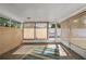 Enclosed sunroom with brick walls and multiple windows at 4410 Ne 13Th St, Ocala, FL 34470