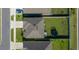 Aerial view of the house showcasing the roof, driveway, and green backyard with a trampoline at 4806 Sw 86Th Ln, Ocala, FL 34476