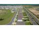 Aerial view of a residential street with new homes, showcasing a Gathering-friendly neighborhood with sidewalks and green spaces at 4806 Sw 86Th Ln, Ocala, FL 34476