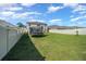 Wide angle view of the large green backyard with a trampoline and a privacy fence at 4806 Sw 86Th Ln, Ocala, FL 34476
