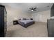 Large bedroom featuring neutral carpet, ceiling fan, and ample space for relaxation and entertainment at 4806 Sw 86Th Ln, Ocala, FL 34476