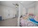 Well-lit bedroom with a bed, ceiling fan, and neutral decor at 4806 Sw 86Th Ln, Ocala, FL 34476