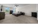 Spacious bedroom showcasing plush carpeting, two large windows, and tasteful dark wood furniture at 4806 Sw 86Th Ln, Ocala, FL 34476