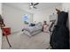 Inviting bedroom with ample space, a ceiling fan, and a window offering pleasant views at 4806 Sw 86Th Ln, Ocala, FL 34476