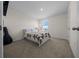 Cozy bedroom features a comfortable bed, neutral decor, and a bright window for natural light at 4806 Sw 86Th Ln, Ocala, FL 34476