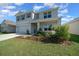 Charming two-story home featuring a well-maintained front yard and attached two-car garage at 4806 Sw 86Th Ln, Ocala, FL 34476
