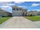 Attractive two-story home with an attached two-car garage, showcasing a well-kept lawn and inviting front entrance at 4806 Sw 86Th Ln, Ocala, FL 34476