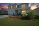 Charming two-story home with a well-manicured lawn and inviting front porch at sunset at 4806 Sw 86Th Ln, Ocala, FL 34476