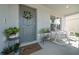 Cozy front porch featuring a 'Welcome' mat, decorative wreath, and comfortable rocking chairs at 4806 Sw 86Th Ln, Ocala, FL 34476