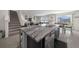 Modern kitchen featuring a spacious island with bar seating, stainless steel appliances, and granite countertops at 4806 Sw 86Th Ln, Ocala, FL 34476
