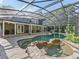 Exterior of home featuring screened in pool and large patio at 6577 Nw 193Rd St, Micanopy, FL 32667