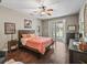 Comfortable bedroom with a ceiling fan, wooden floors and access to the outdoor area at 6577 Nw 193Rd St, Micanopy, FL 32667