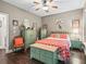 Stylish bedroom featuring hardwood floors, mint furniture and vibrant orange accents at 6577 Nw 193Rd St, Micanopy, FL 32667