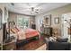 Cozy bedroom with french doors, ceiling fan, and dark hardwood floors at 6577 Nw 193Rd St, Micanopy, FL 32667