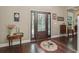 Inviting foyer featuring a decorative rug, hardwood floors, and a stylish front door at 6577 Nw 193Rd St, Micanopy, FL 32667