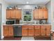 The kitchen features wood cabinets, granite countertops, stainless appliances, and a window above the sink at 6577 Nw 193Rd St, Micanopy, FL 32667