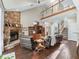 Living room with hardwood floors, a stone fireplace, and a staircase at 6577 Nw 193Rd St, Micanopy, FL 32667